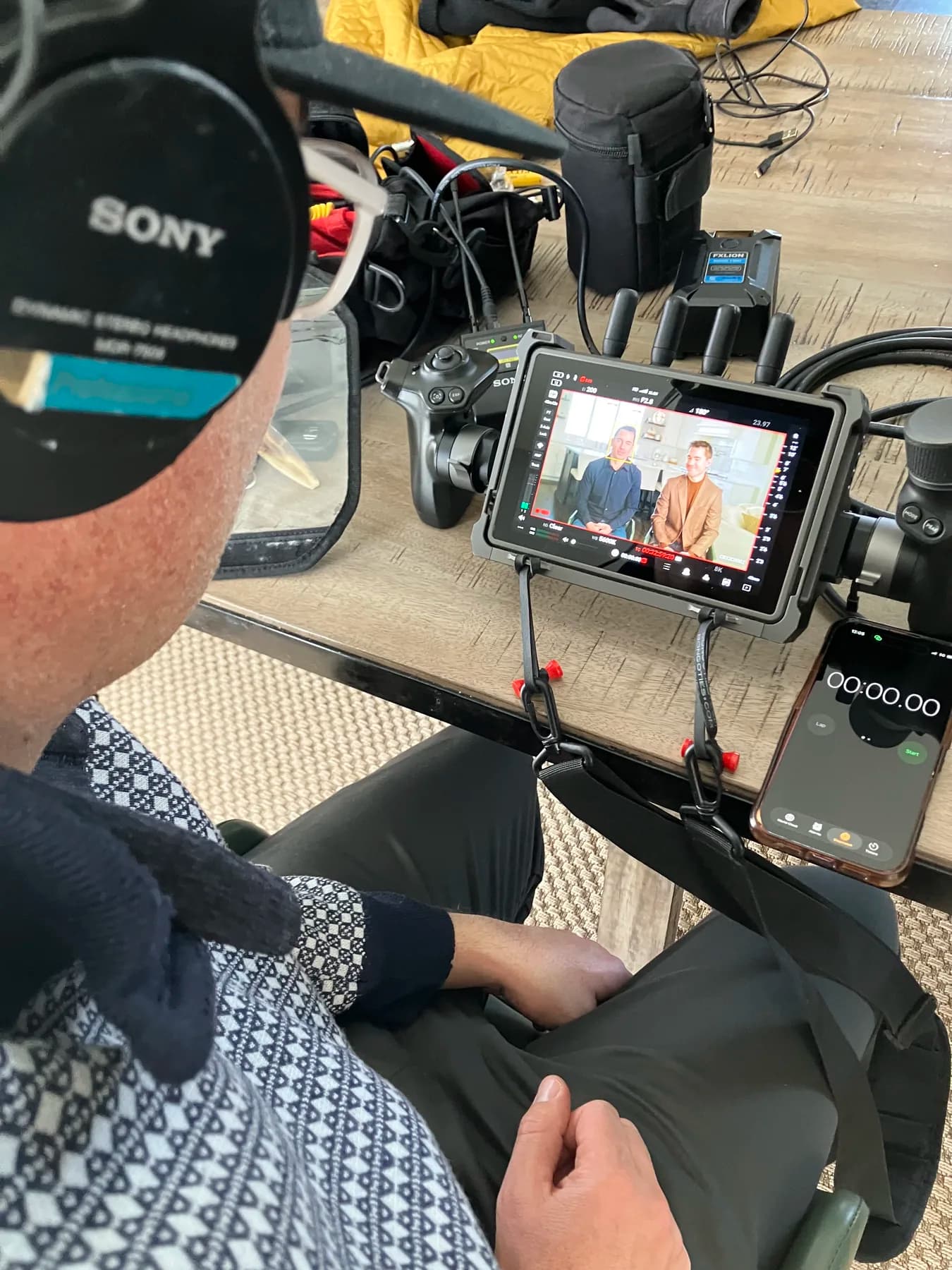 Over-the-shoulder view of the monitor during Boer Insurance brand video playback with the SALT crew on set.