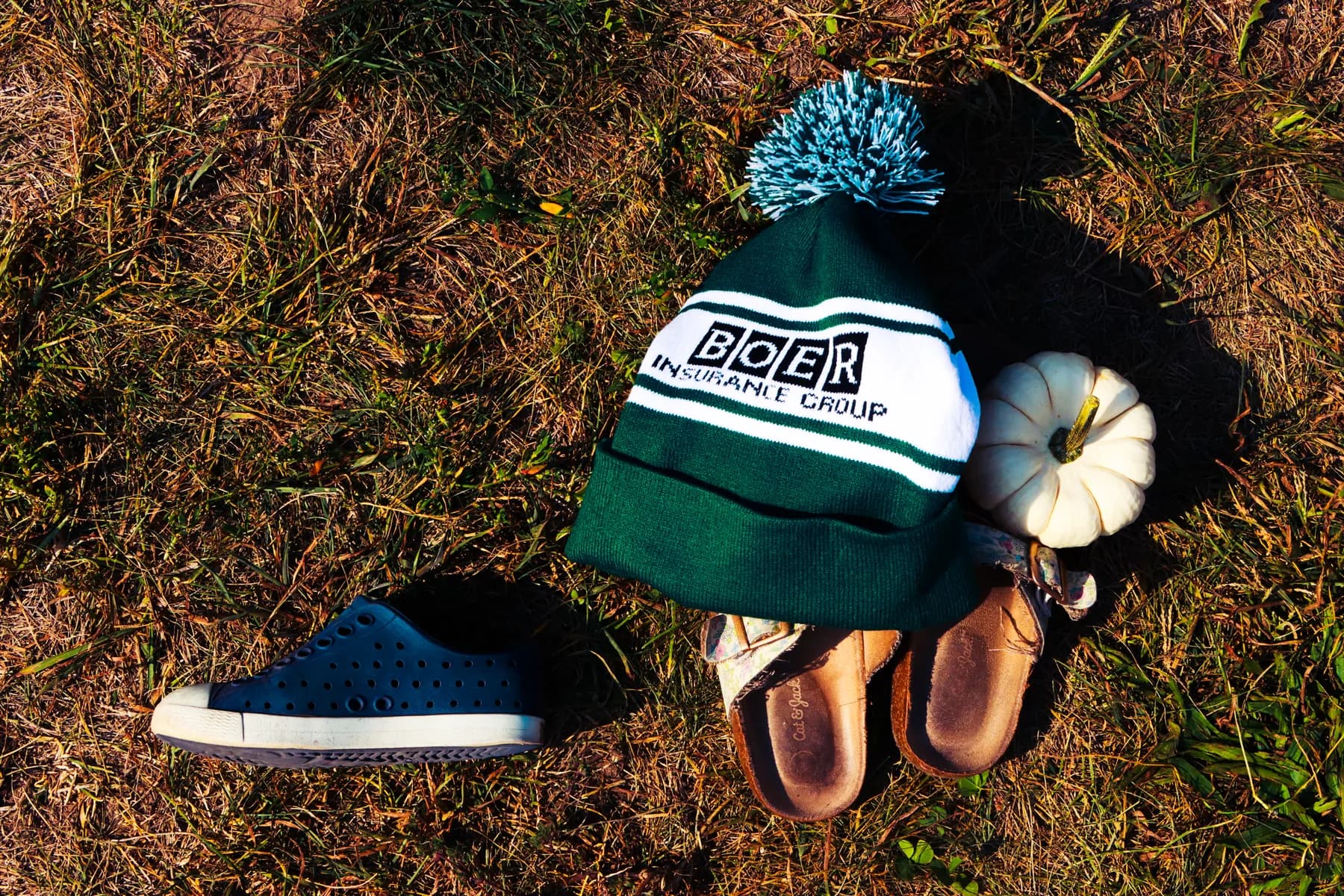 A Boer Insurance Group knit hat placed with seasonal items during customer appreciation day at Robinette's Apple Haus.