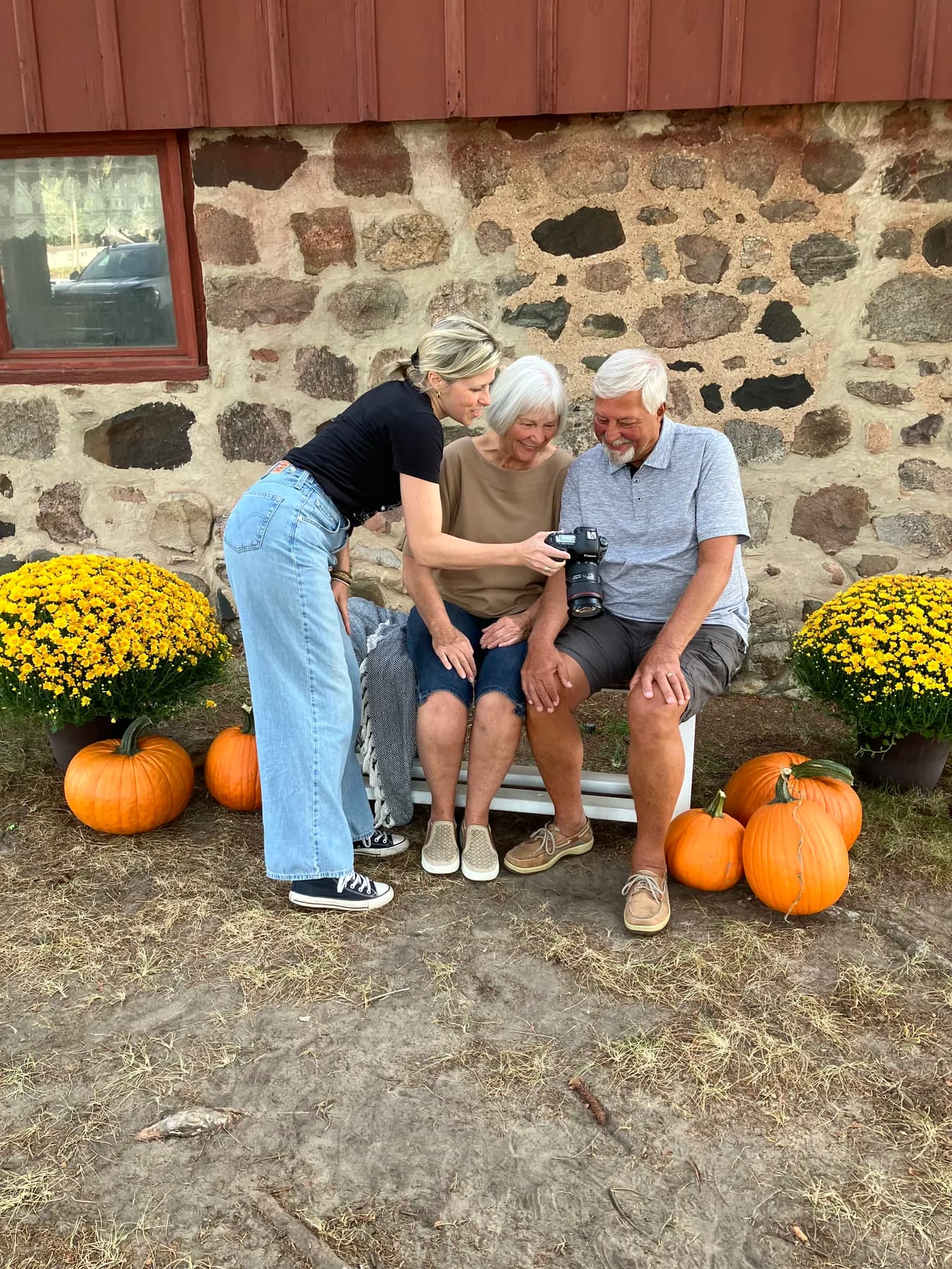 A SALT photographer shows a client couple their portrait during Boer Insurance customer appreciation day at Robinette's Apple Haus.
