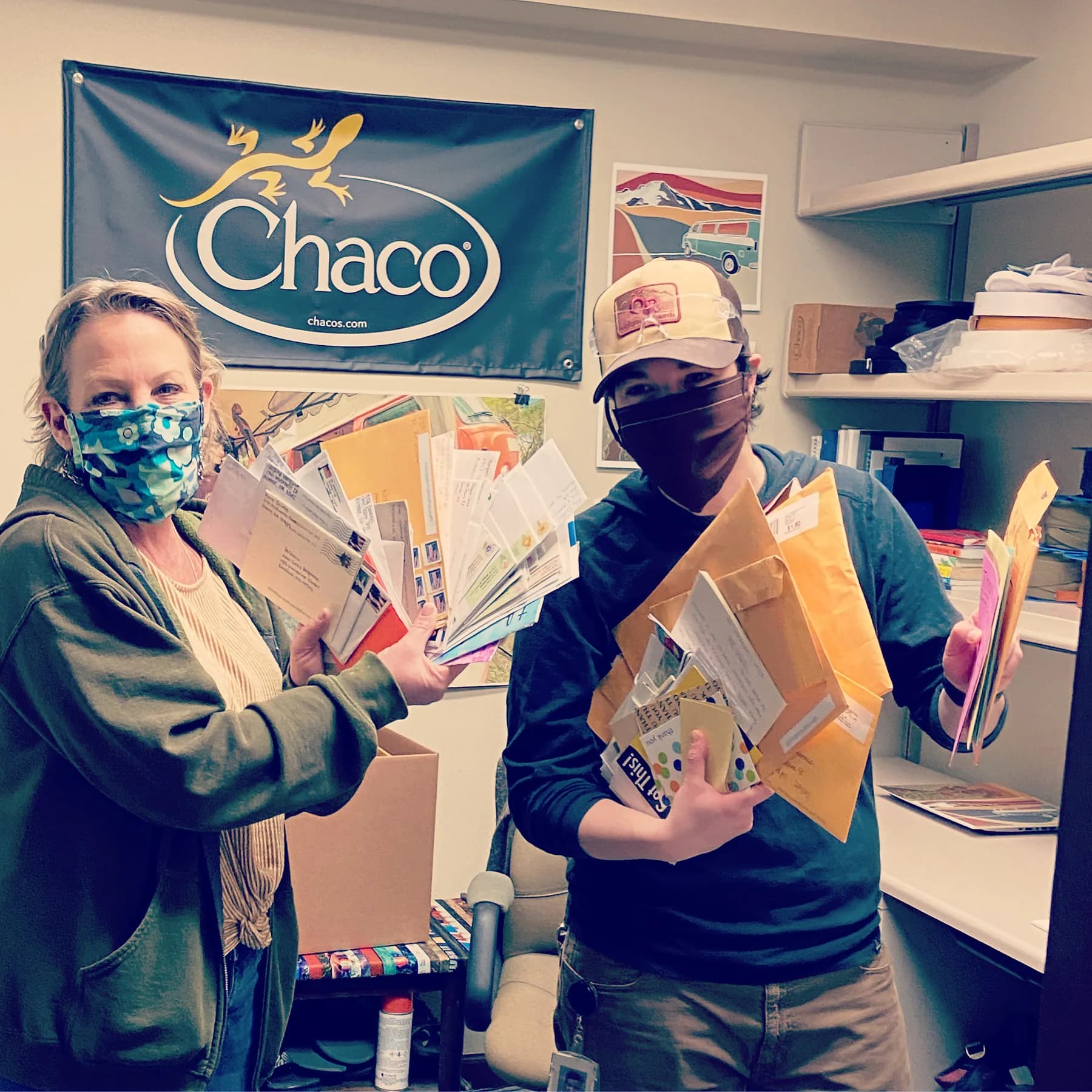 Lisa Kondrat and Bianca Vasovski hold stacks of thank-you letters during the GR Strong production at Wolverine Worldwide.