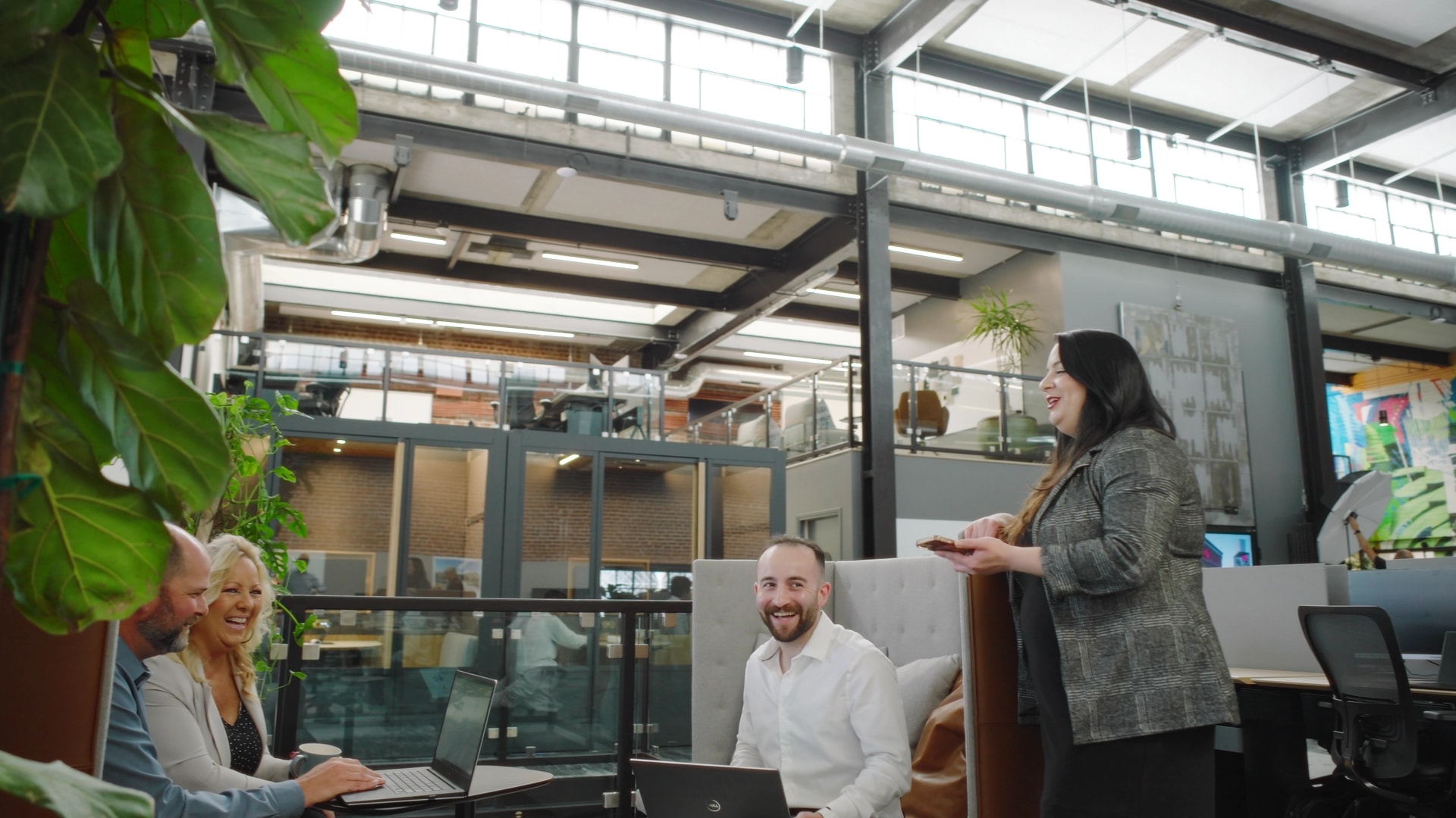 Open-concept LPAS Sacramento office with exposed brick, skylight, and collaborative seating