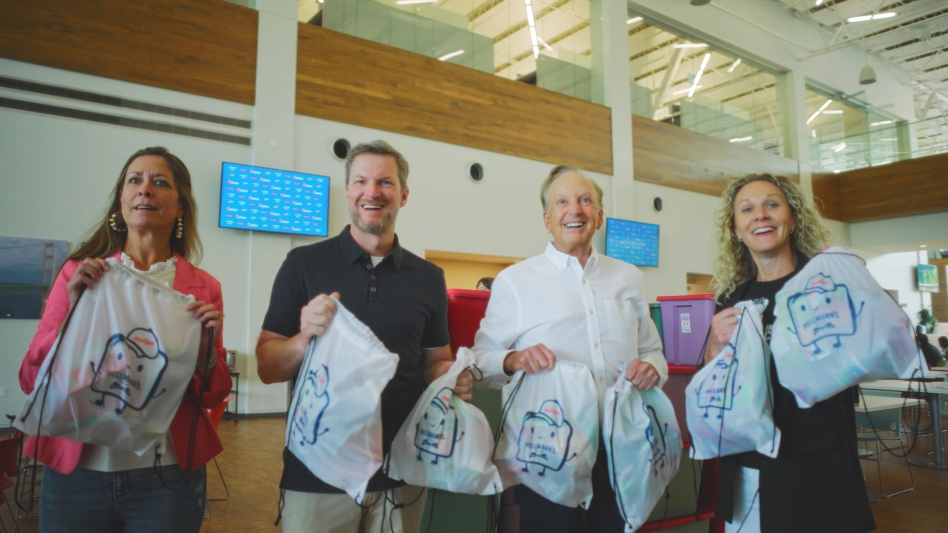 Dale Earnhardt Jr packing backpacks with volunteers during a Meijer and Hellmann's charity event