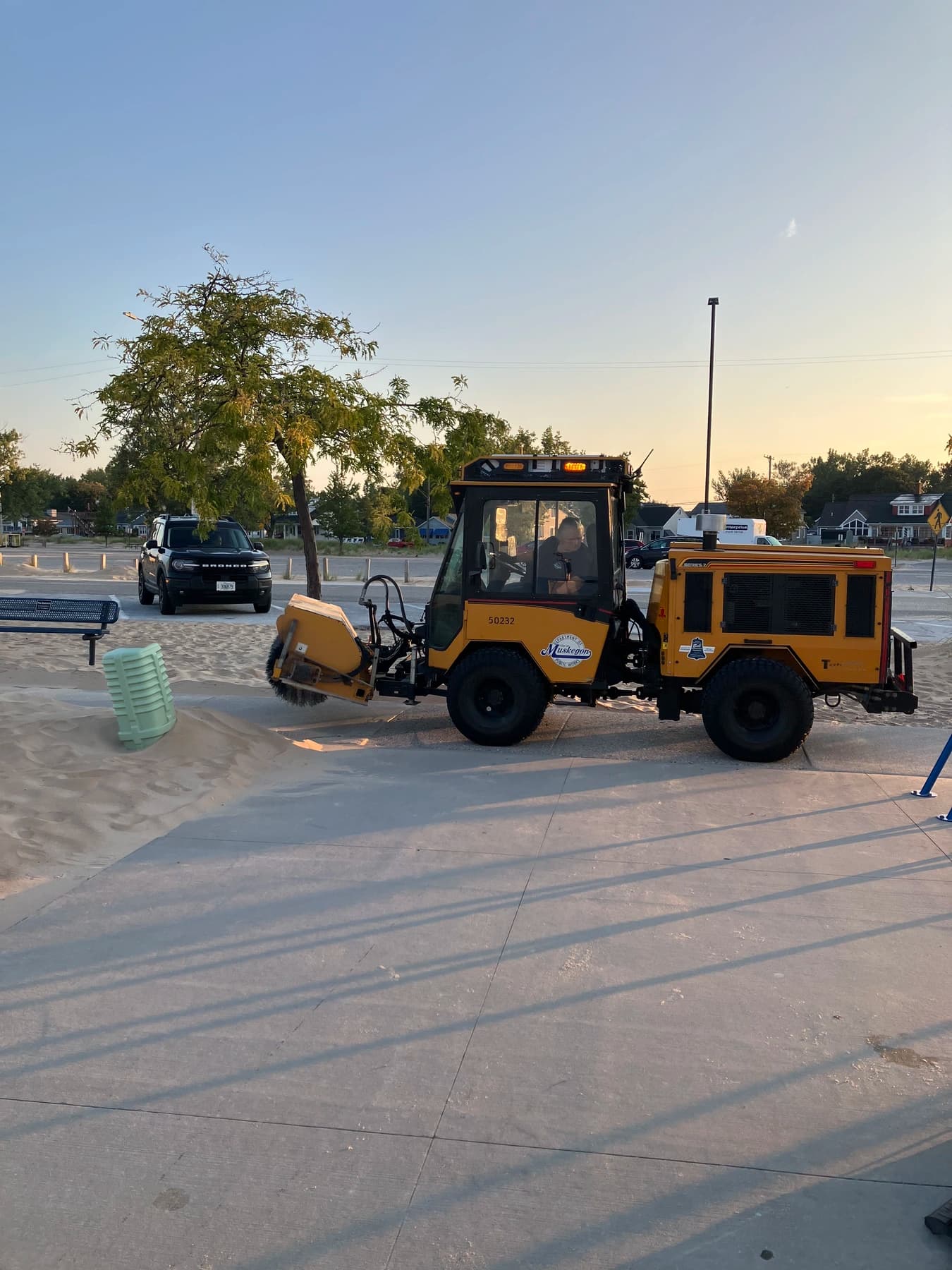 Beach restoration machinery parked near the cleanup production area during the Unilever and Meijer Beach Cleanup.