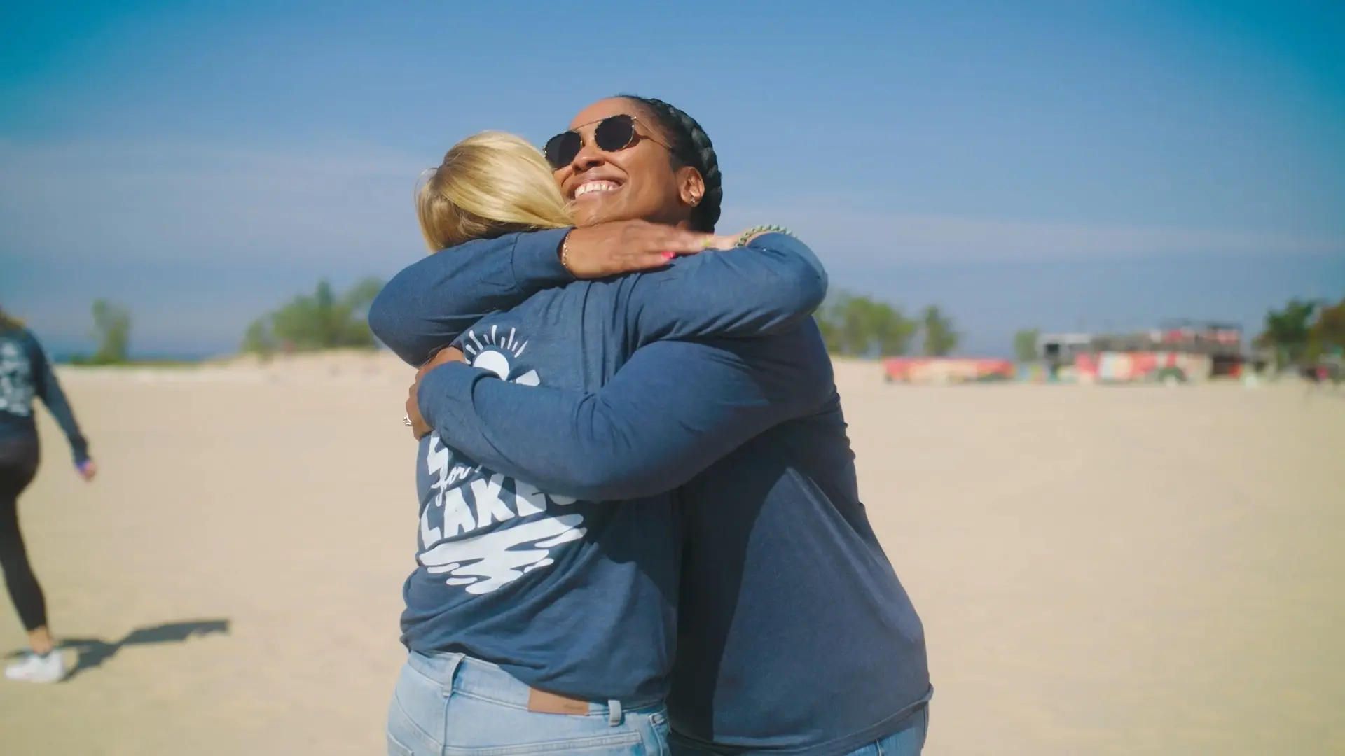 Volunteers removing micro-plastics during a Lake Michigan beach cleanup